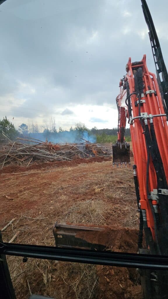 Heavy machinery clearing land for construction or development projects.